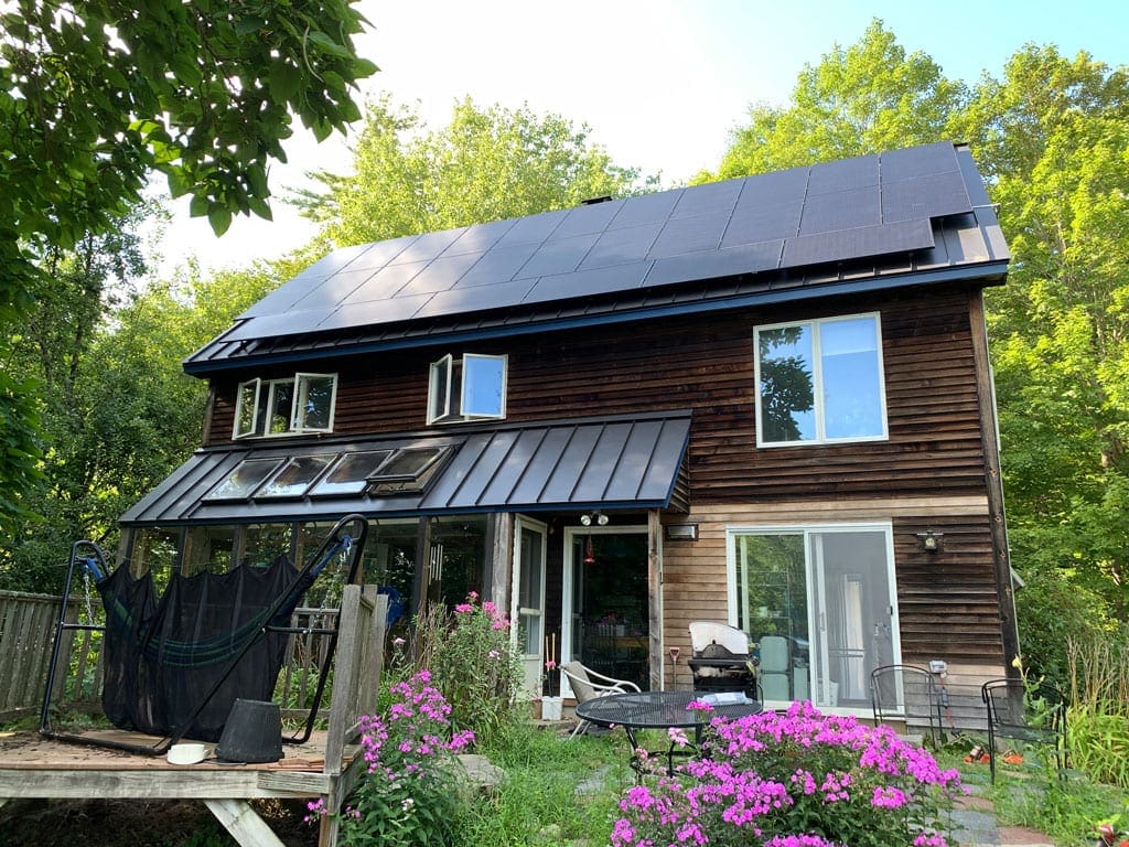 Here's an image of a NH solar panel installation we performed, taken from the rear of the house from the ground. We installed residential rooftop solar panels on the metal roof of this home.